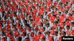 Students wave the Vietnamese national flag