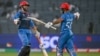 Afghanistan's Azmatullah Omarzai (L) celebrates with his captain Hashmatullah Shahidi after scoring a half-century (50 runs) during the 2023 ICC Men's Cricket World Cup one-day international (ODI) match between Afghanistan and Sri Lanka at the Maharashtra