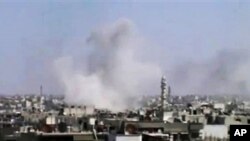 Khói bốc lên sau vụ pháo kích ở Homs, Syria, 10/4/2012