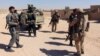 FILE - Afghan Special Forces and policemen prepare for battle with the Taliban on the outskirts of Lashkar Gah, capital of Helmand, Afghanistan, Oct. 10, 2016.