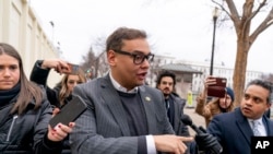 Congressman George Santos responds to reporters' questions as he leaves a House Republican conference meeting on Capitol Hill in Washington, Jan. 25, 2023. 