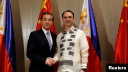 Bộ trưởng Ngoại giao Philippines Alan Peter Cayetano (phải) bắt tay Ngoại trưởng Trung Quốc Vương Nghị ở Taguig, Nội đô Manila, Philippines, ngày 25 tháng 7, 2017.