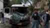 Afghan police stand at the site of a suicide car bomb attack in Kabul, June 11, 2013.