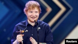 FILE - British singer Ed Sheeran poses with the 'Golden Camera' ('Die Goldene Kamera') award during the ceremony of German TV magazine 'Hoer Zu' in Hamburg, March 4, 2017. 