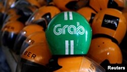 Grab và Uber thông báo thỏa thuận mua bán tuần trước.