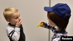 Harrison, 5, who is autistic, plays with Kaspar, a child-sized humanoid robot developed at the University of Hertfordshire Jan. 30, 2017.