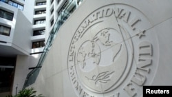 FILE - The International Monetary Fund logo is seen inside its headquarters at the end of the IMF/World Bank annual meetings in Washington.